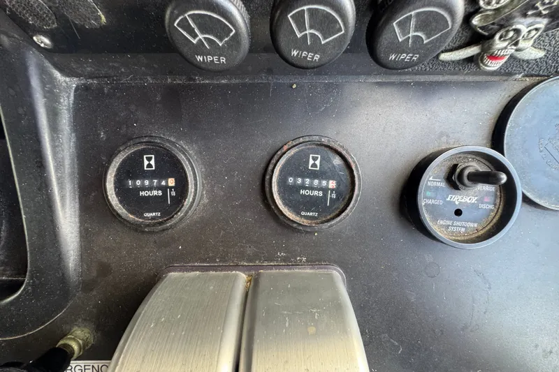 Slide: The Image of Control panel of a 1989 Ocean Yachts 48 Motor Yacht with hour meters and switches. - 82