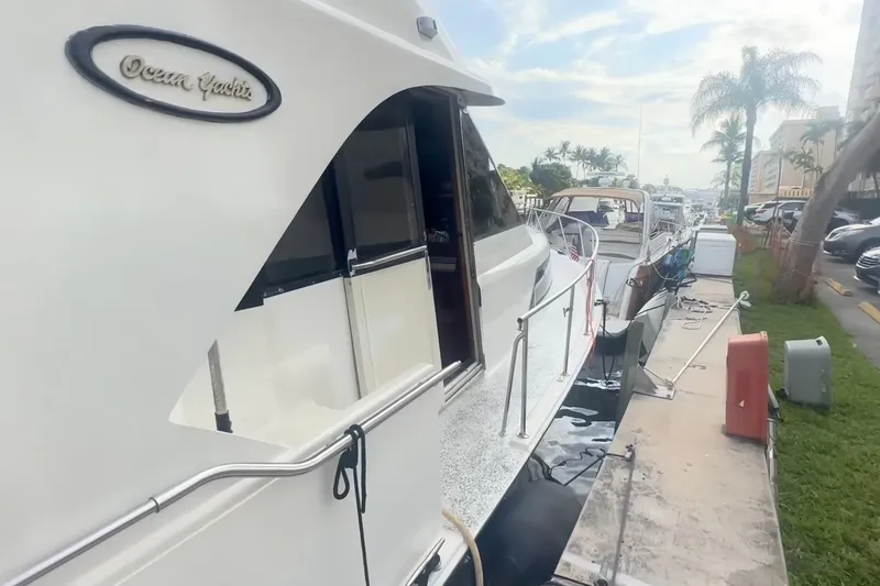 Slide: The Image of 1989 Ocean Yachts 48 Motor Yacht docked, showcasing sleek design and marina setting. - 3