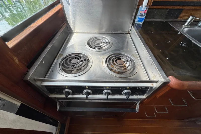 Slide: The Image of Electric stove in 1989 Ocean Yachts 48 Motor Yacht kitchen, featuring three burners. - 71