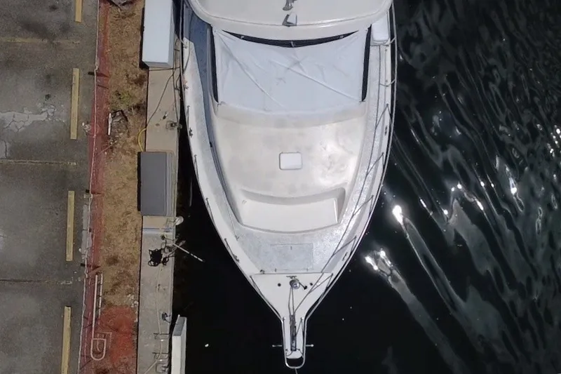 Slide: The Image of Aerial view of a 1989 Ocean Yachts 48 Motor Yacht docked by the water. - 4