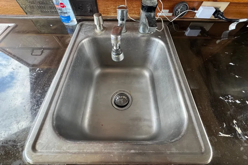Slide: The Image of Stainless steel sink on 1989 Ocean Yachts 48 Motor Yacht with faucet and countertop items. - 73
