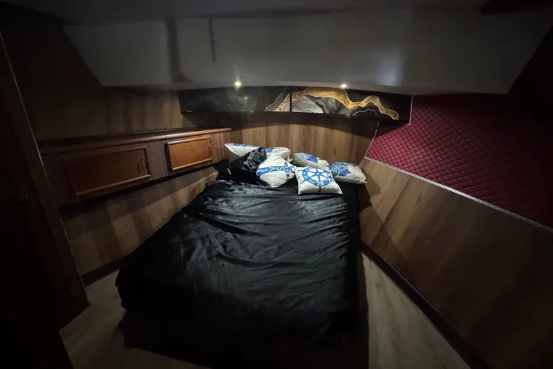 Slide: The Image of Cozy bedroom in 1989 Ocean Yachts 48 Motor Yacht with nautical-themed pillows. - 88