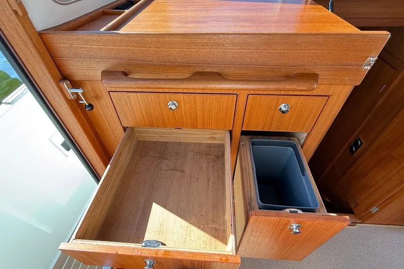 Slide: The Image of Wooden cabinetry with open drawers in a 2024 Targa 37 boat interior. - 34