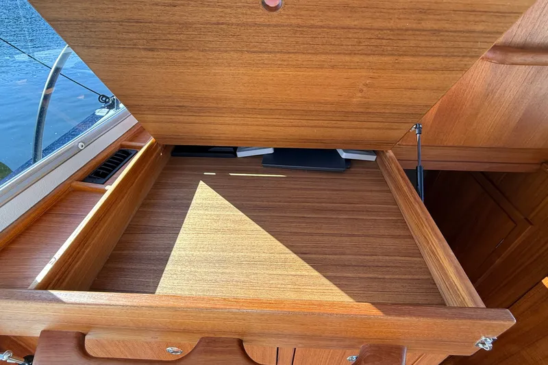 Slide: The Image of 2024 Targa 37 boat interior with open wooden storage compartment. - 32
