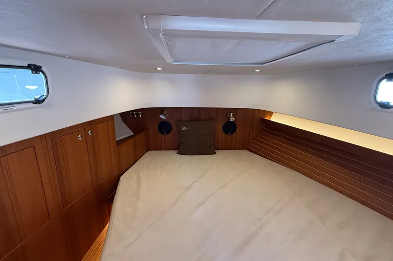 Slide: The Image of Cozy cabin interior of 2024 Targa 37 boat with wooden accents and natural light. - 51