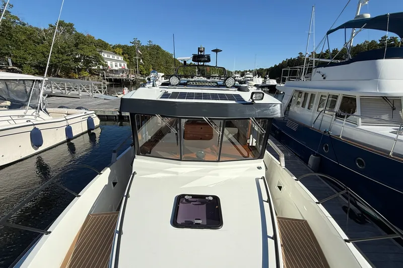 Slide: The Image of 2024 Targa 37 boat docked at marina, surrounded by other vessels. - 59