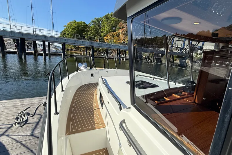 Slide: The Image of 2024 Targa 37 boat docked, showcasing sleek design and spacious deck area. - 56