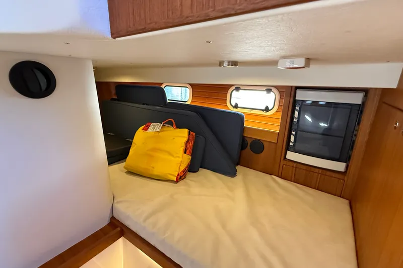 Slide: The Image of Interior cabin of 2024 Targa 37 boat with bed, window, and storage. - 13