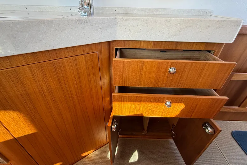 Slide: The Image of Wooden cabinetry with open drawers and doors in a 2024 Targa 37 boat interior. - 20