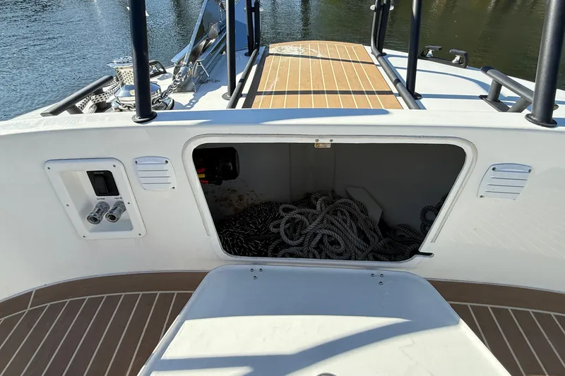 Slide: The Image of 2024 Targa 37 boat deck with open storage compartment and ropes. - 58