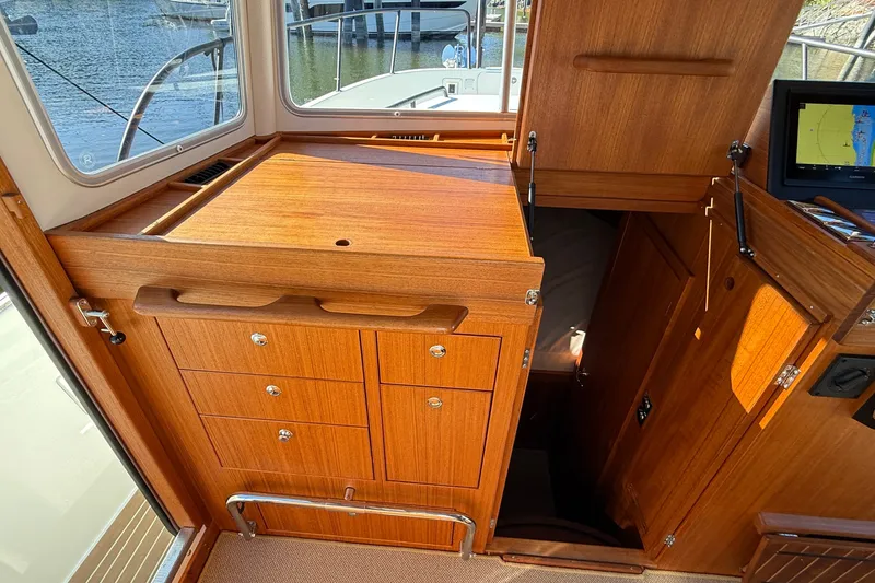 Slide: The Image of 2024 Targa 37 yacht interior with wooden cabinetry and navigation equipment. - 31