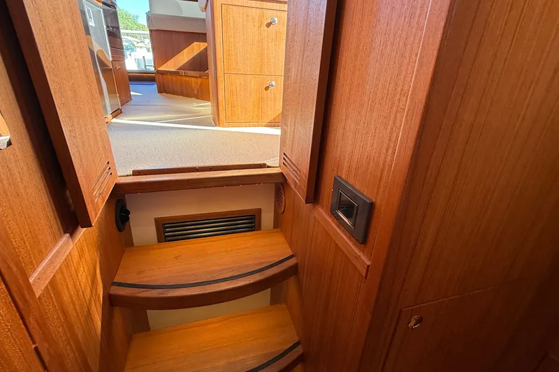 Slide: The Image of Interior of 2024 Targa 37 boat, featuring wooden stairs and cabinetry. - 53