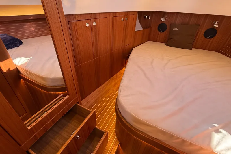 Slide: The Image of Luxurious 2024 Targa 37 cabin interior with wooden finish and cozy bedding. - 43