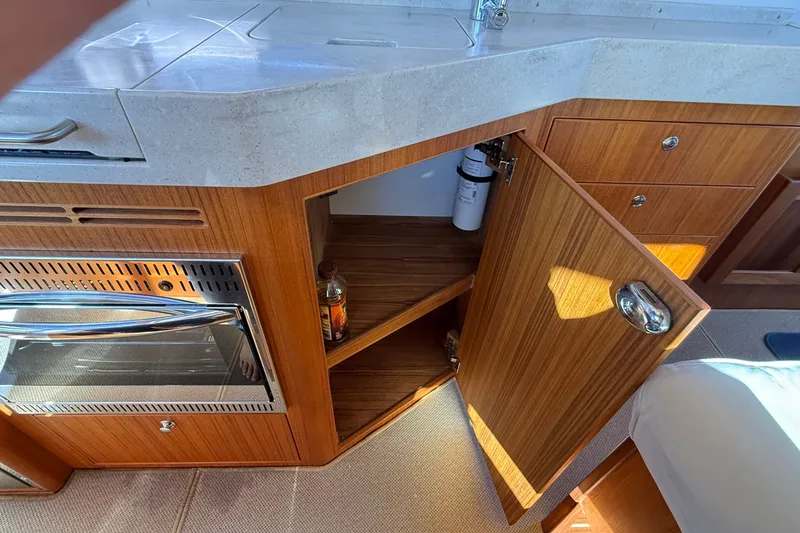 Slide: The Image of Interior of 2024 Targa 37 yacht showing wooden cabinetry and open storage space. - 23