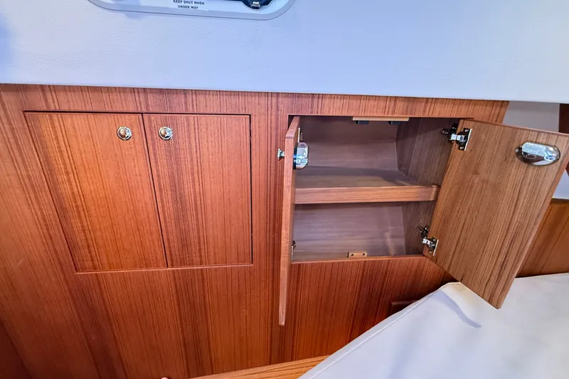 Slide: The Image of Wooden cabinet interior on a 2024 Targa 37 boat, showcasing open storage space. - 46