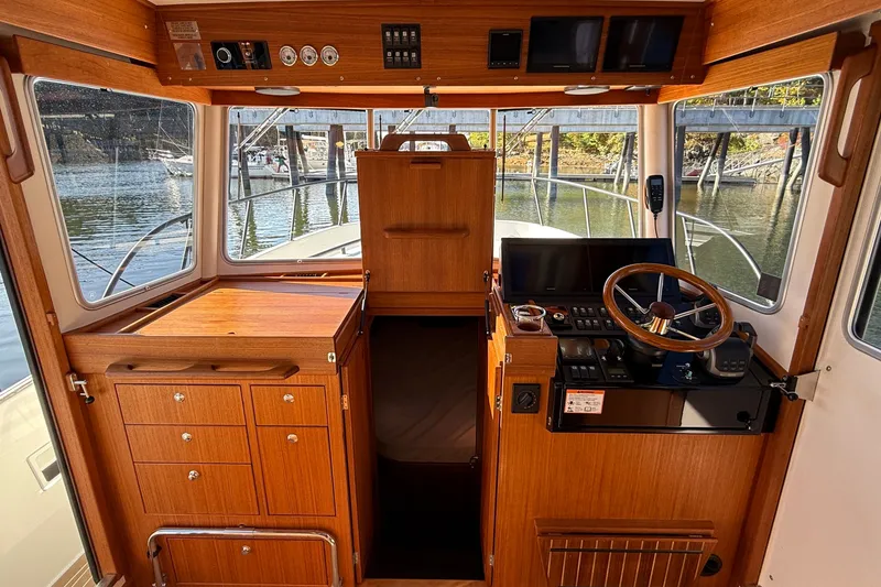 Slide: The Image of 2024 Targa 37 boat interior with wooden cabinetry and steering console. - 27