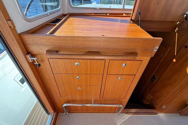 Slide: The Image of Wooden cabinetry inside a 2024 Targa 37 boat, featuring multiple drawers and a polished finish. - 36