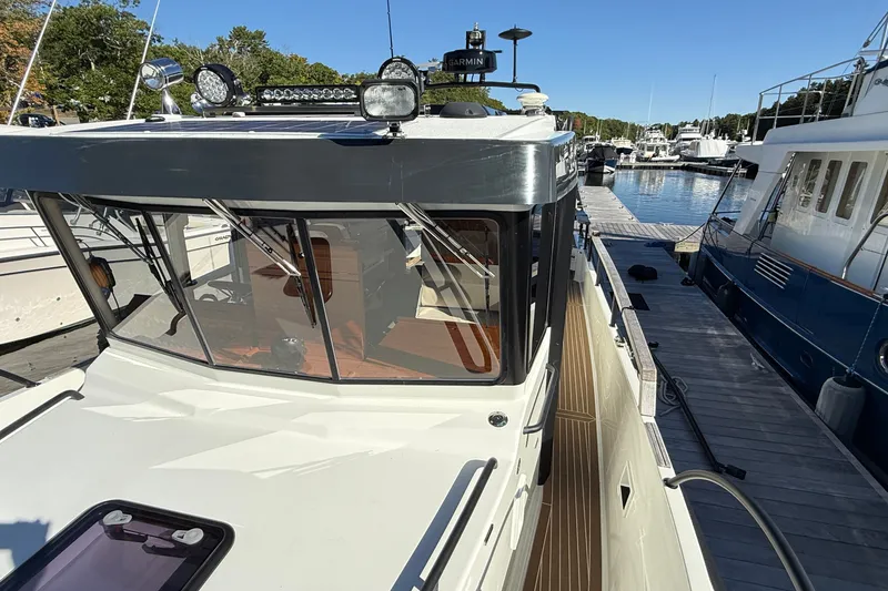 Slide: The Image of 2024 Targa 37 boat docked at marina, showcasing sleek design and modern features. - 62