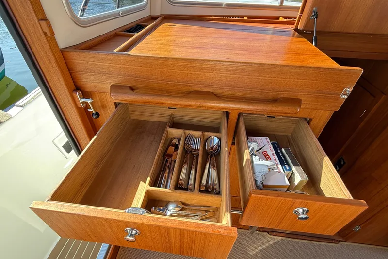 Slide: The Image of Wooden interior drawers in a 2024 Targa 37 boat, featuring organized cutlery and storage. - 33