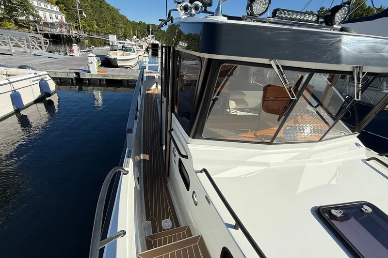 Slide: The Image of 2024 Targa 37 boat docked at marina, showcasing sleek design and modern features. - 60