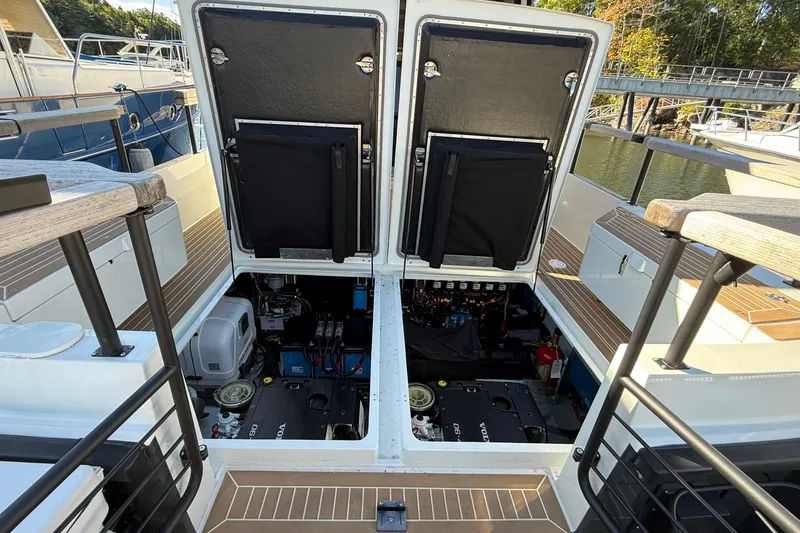 Slide: The Image of 2024 Targa 37 boat engine compartment with open hatches, showcasing mechanical components. - 65