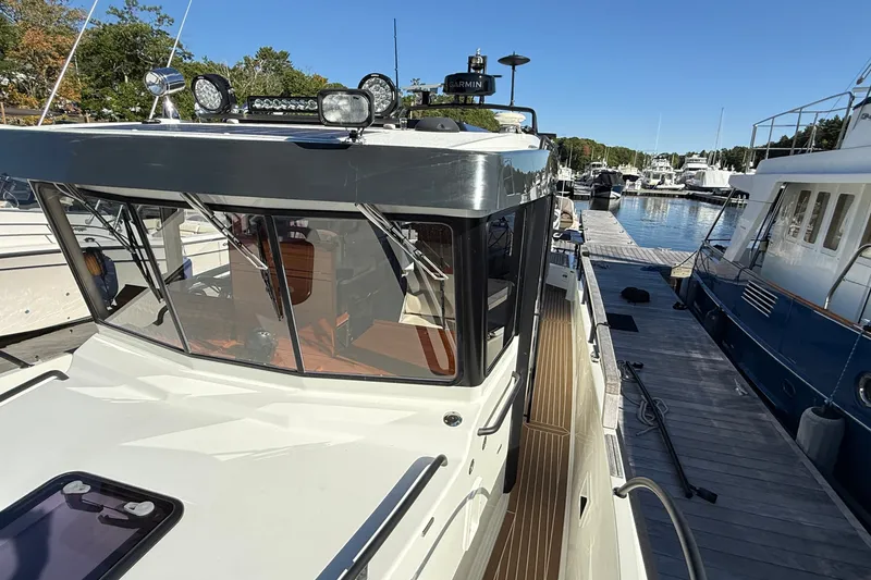 Slide: The Image of 2024 Targa 37 boat docked at marina, showcasing sleek design and modern features. - 63