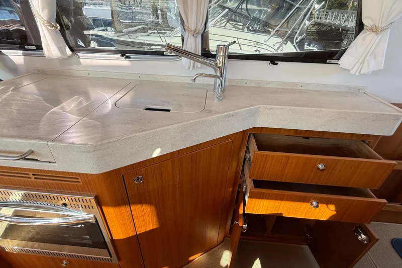 Slide: The Image of Modern kitchen area in 2024 Targa 37 boat with wooden cabinets and sleek countertop. - 21