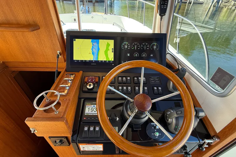Slide: The Image of 2024 Targa 37 helm with wooden steering wheel and advanced navigation display. - 15