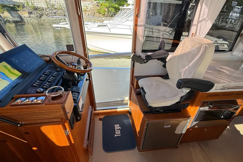 Slide: The Image of Helm of 2024 Targa 37 boat with modern controls and comfortable seating. - 38