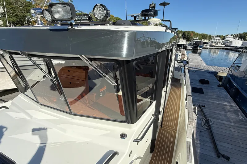 Slide: The Image of 2024 Targa 37 boat docked at marina, showcasing sleek design and modern features. - 61