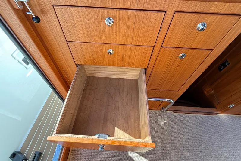 Slide: The Image of Open wooden drawer in 2024 Targa 37 boat interior, showcasing sleek design and craftsmanship. - 35