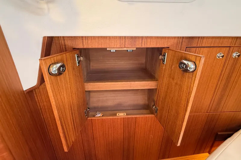 Slide: The Image of Open wooden cabinet in 2024 Targa 37 boat interior, showcasing storage space. - 45