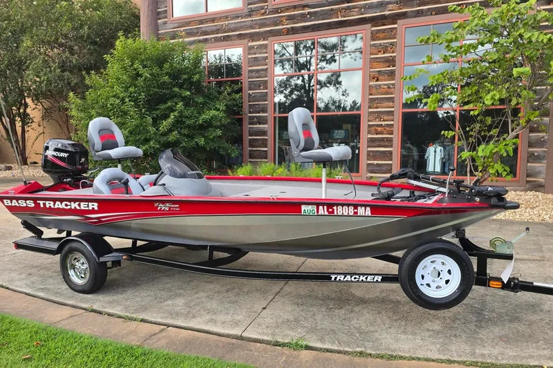 The Image of 2010 Tracker Pro Team 175 TXW bass boat on trailer, parked outdoors. - 0