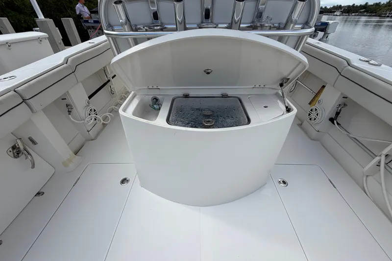 Slide: The Image of 2014 Jupiter 34 FS boat interior with open storage compartment and seating. - 20