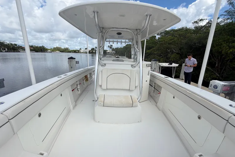 Slide: The Image of 2014 Jupiter 34 FS boat interior with seating, docked by a calm river. - 77