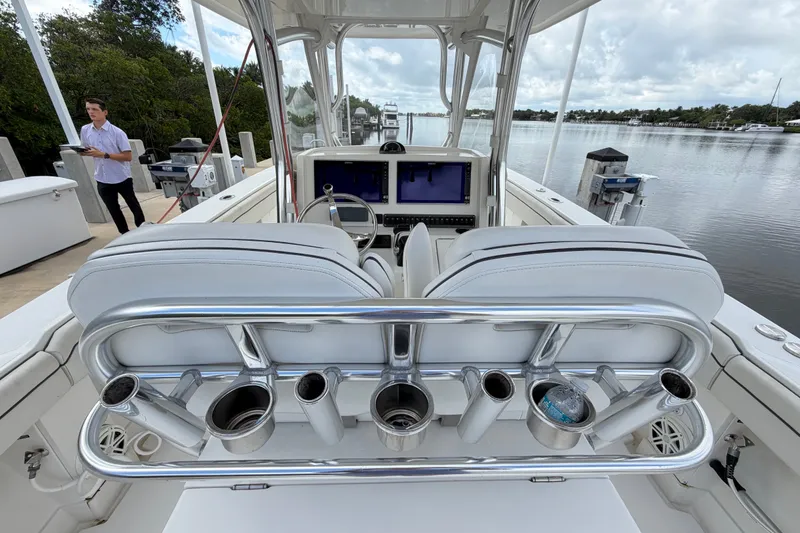 Slide: The Image of 2014 Jupiter 34 FS boat interior with helm, rod holders, and water view. - 18
