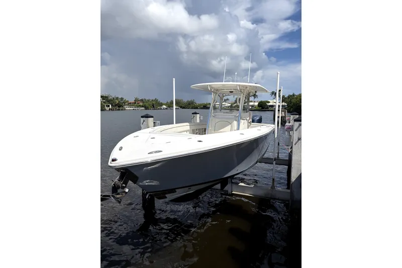 The Image of 2015 Jupiter 34 FS boat docked on a sunny day with cloudy sky. - 0