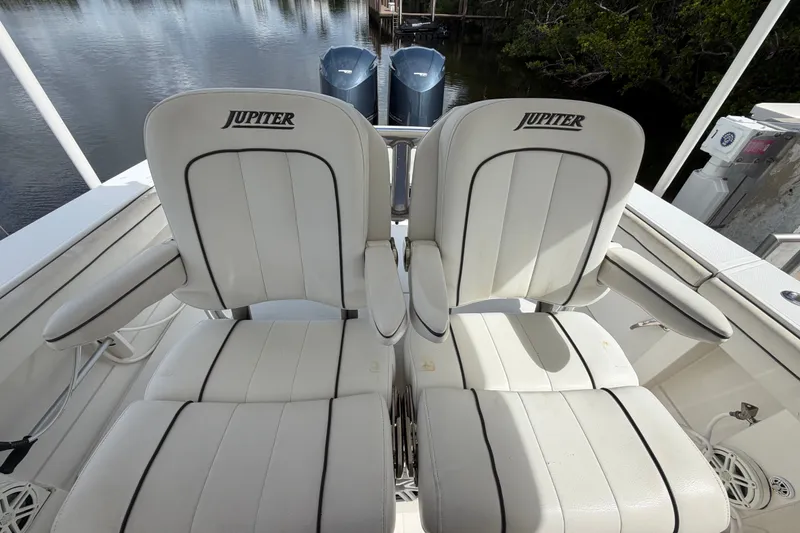 Slide: The Image of 2014 Jupiter 34 FS boat seats with logo, featuring dual outboard motors in the background. - 35