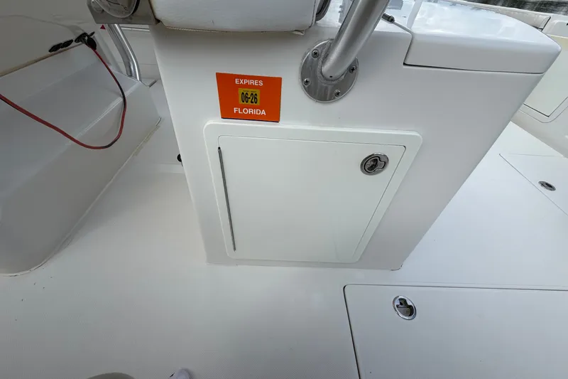 Slide: The Image of 2014 Jupiter 34 FS boat interior with Florida registration sticker expiring 06-26. - 38