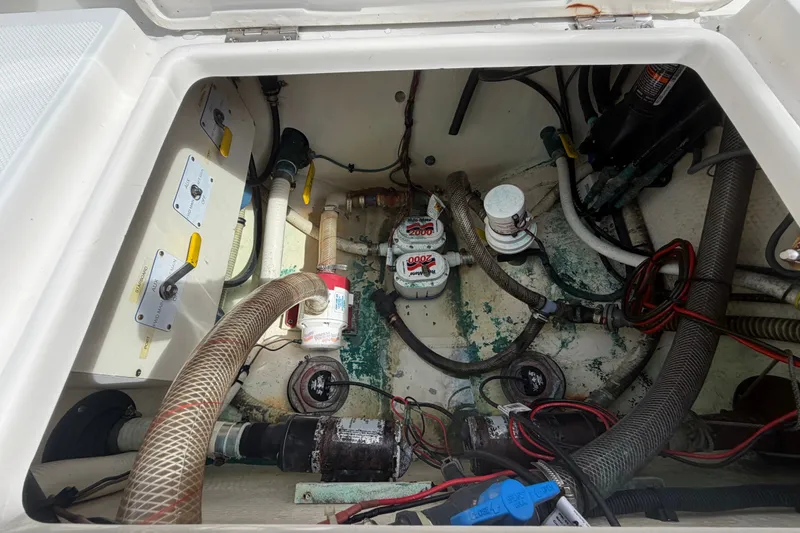 Slide: The Image of Engine compartment of a 2014 Jupiter 34 FS boat, showing hoses and wiring. - 80