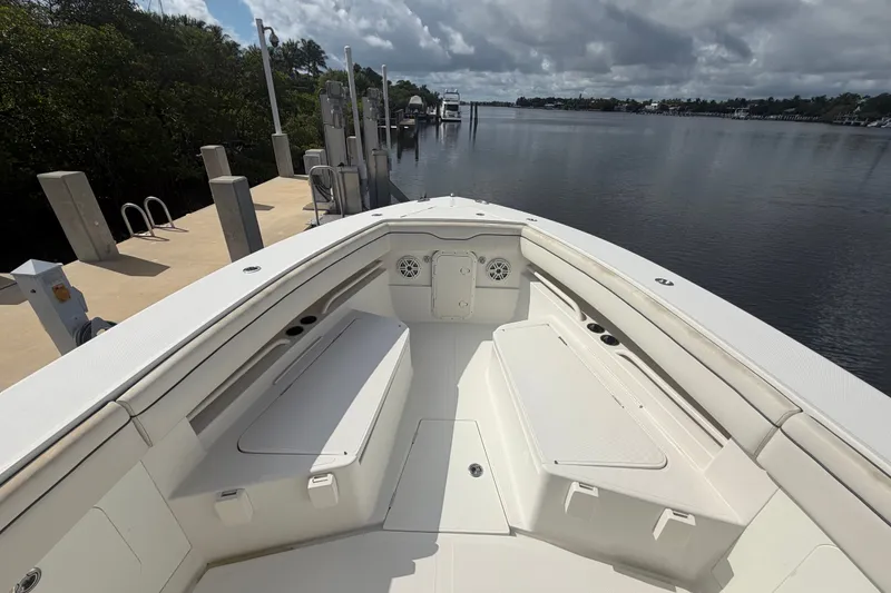Slide: The Image of 2014 Jupiter 34 FS boat docked by a calm waterfront under cloudy skies. - 55