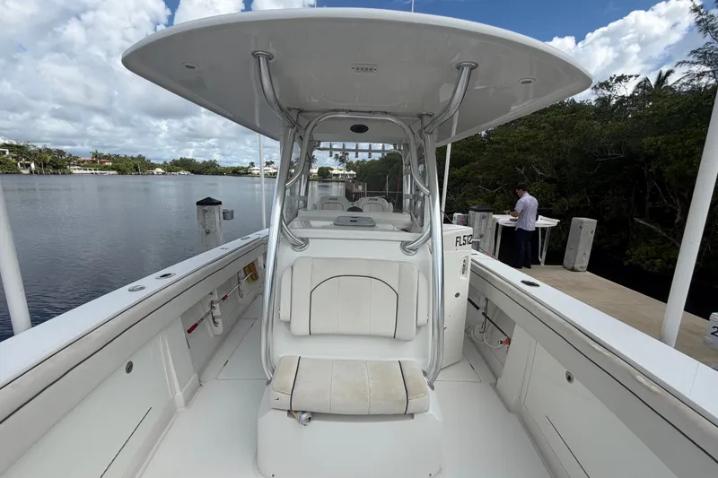 Slide: The Image of 2014 Jupiter 34 FS boat docked by a serene waterfront with lush greenery. - 74
