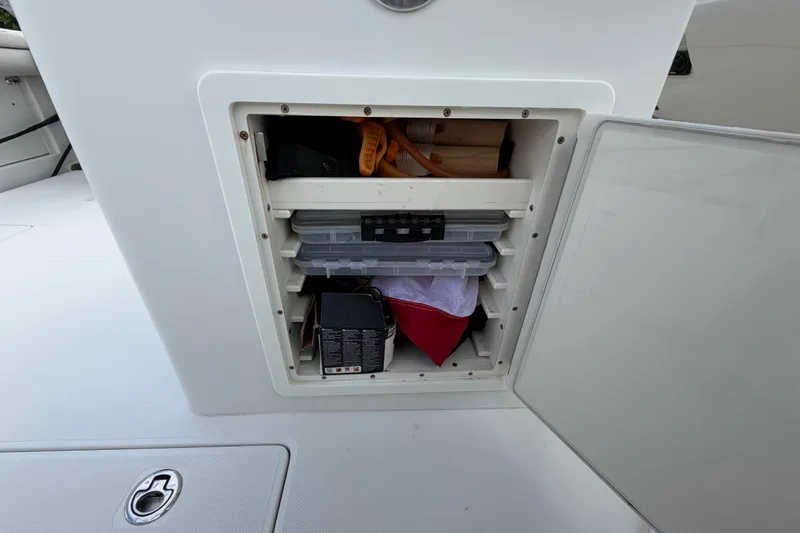 Slide: The Image of Storage compartment on a 2014 Jupiter 34 FS boat, containing various items and equipment. - 37