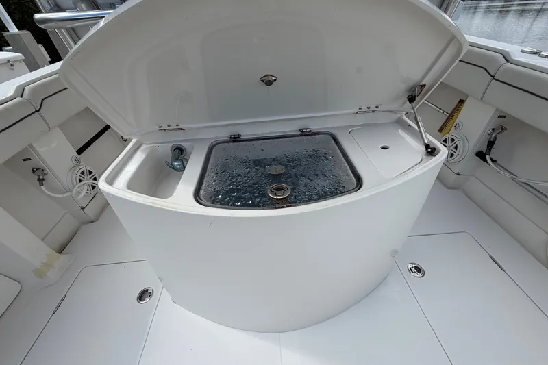 Slide: The Image of 2014 Jupiter 34 FS boat with open livewell and clean deck. - 82