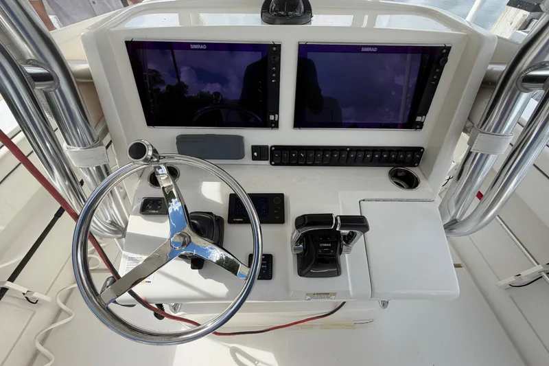 Slide: The Image of 2014 Jupiter 34 FS boat helm with dual Simrad displays and Yamaha controls. - 23