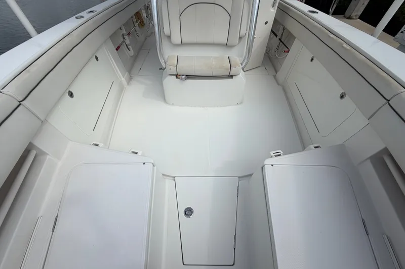 Slide: The Image of 2014 Jupiter 34 FS boat interior with white seating and storage compartments. - 71