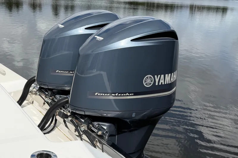 Slide: The Image of Twin Yamaha four-stroke engines on a 2014 Jupiter 34 FS boat, reflecting on water. - 6