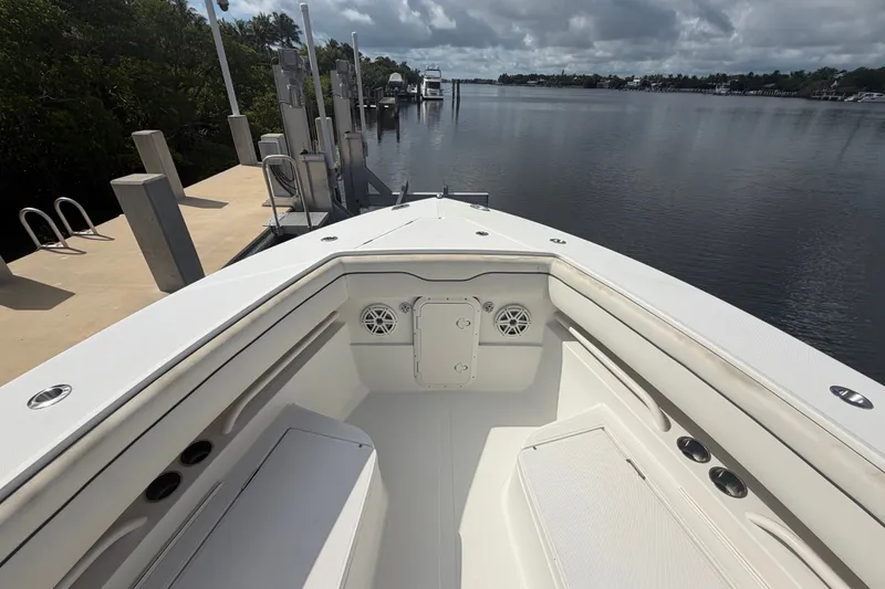 Slide: The Image of 2014 Jupiter 34 FS boat docked by a serene waterfront under cloudy skies. - 61