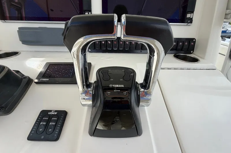 Slide: The Image of Yamaha throttle controls on a 2014 Jupiter 34 FS boat dashboard. - 27