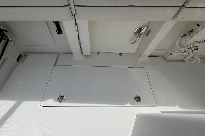 Slide: The Image of Interior of a 2014 Jupiter 34 FS with white walls and storage compartments. - 41